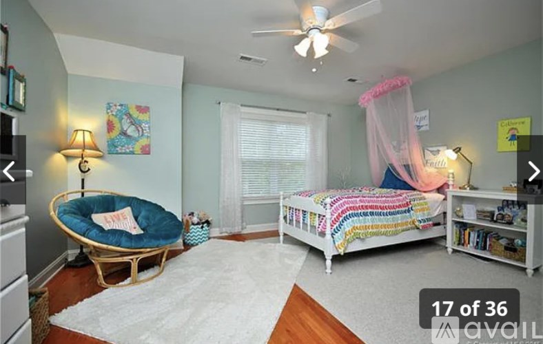 A bedroom with a canopy bed and a daybed.