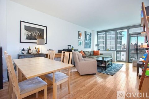 A living room with a dining table and chairs.