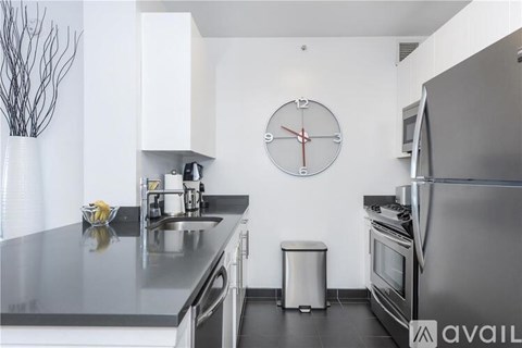 A modern kitchen with a clock on the wall.