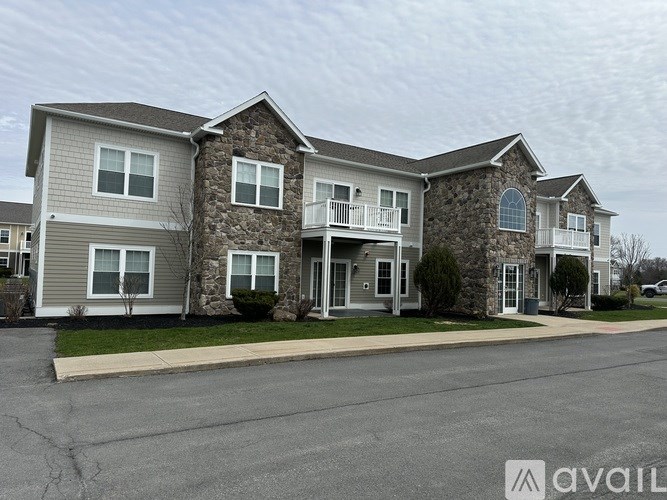 A row of houses with the first one having a balcony.