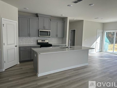 A kitchen with a white countertop and grey cabinets.