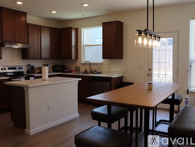 A kitchen with brown cabinets and a white island.