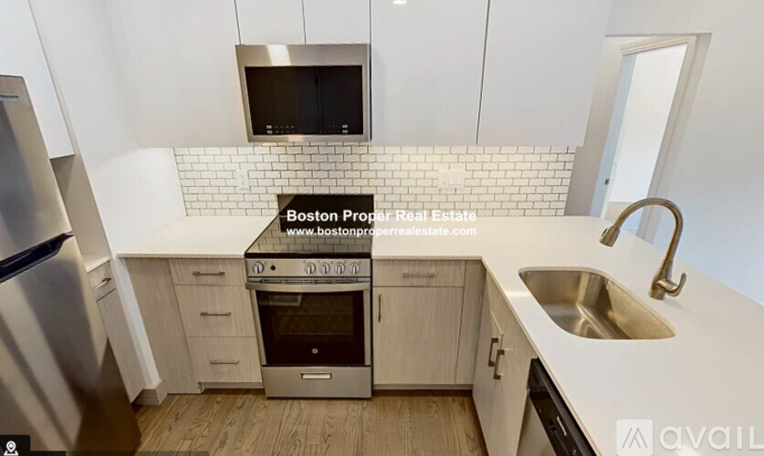 A kitchen with a stove top oven and a microwave above it.