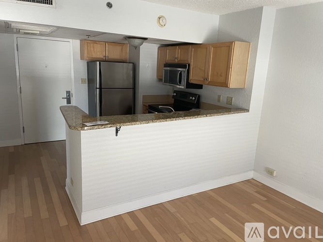 A kitchen with wooden cabinets and a granite countertop.