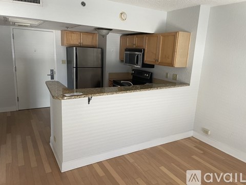 A kitchen with wooden cabinets and a granite countertop.