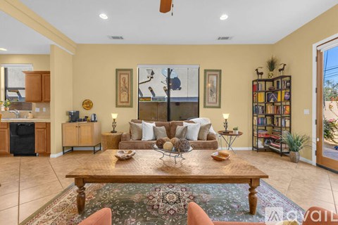 A living room with a brown sofa and a wooden coffee table.