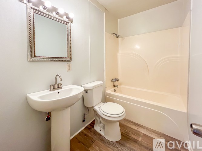 A white bathroom with a sink, toilet and bathtub.