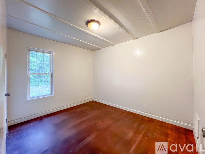A room with wooden floors and a window.