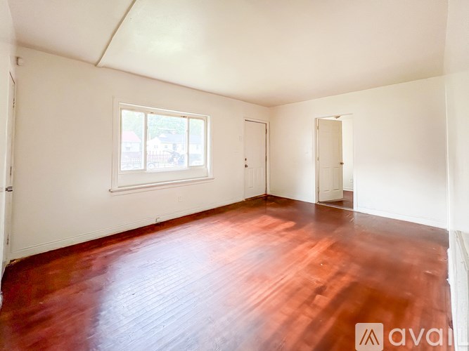 A room with wooden floors and white walls.