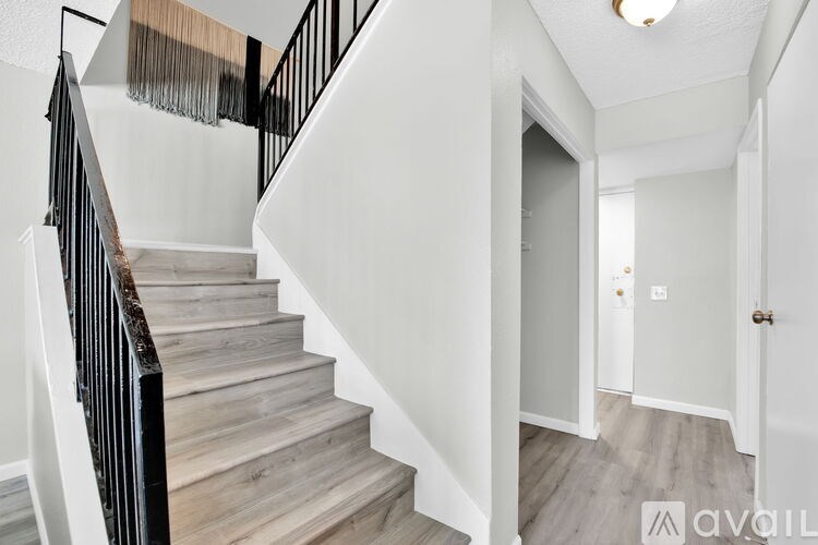 A staircase with wooden steps and black railings.