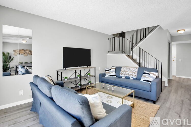 A living room with a blue couch and a television.