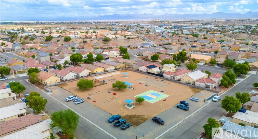 A bird's eye view of a residential area with houses, cars, and a playground.