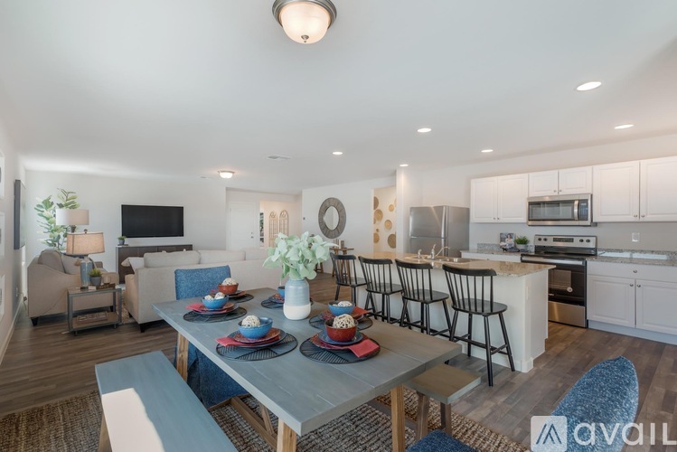 A modern kitchen with a dining table set for four.