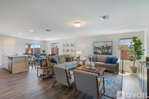 A living room with a grey couch and a wooden coffee table.