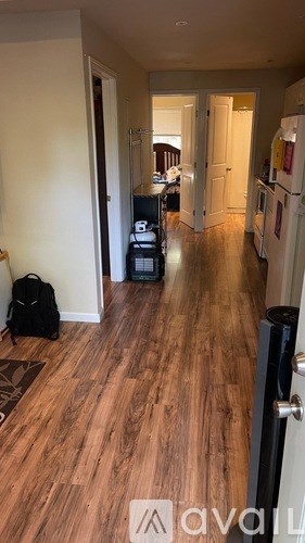 A hallway with a backpack on the floor.