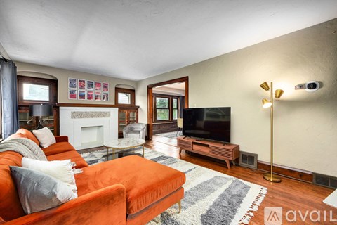 A living room with a fireplace, a television, and a couch.