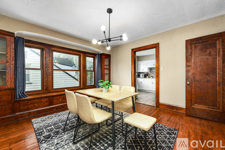 A dining room with a table and chairs.