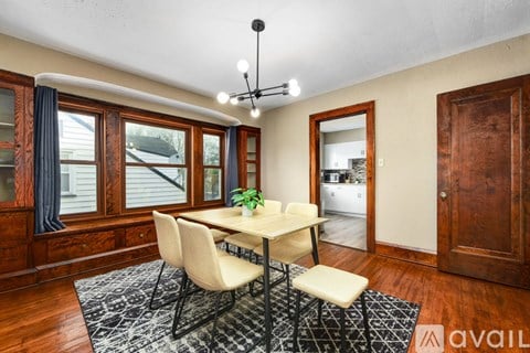 A dining room with a table and chairs.