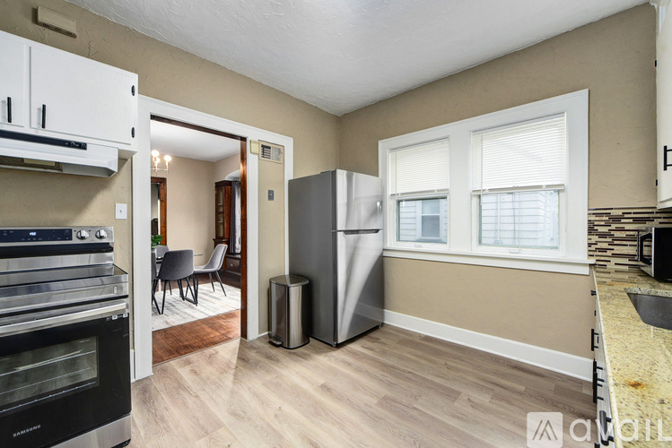 A kitchen with a stove top oven and a refrigerator.