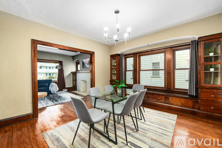 A dining room with a glass table and chairs.