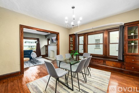 A dining room with a glass table and chairs.