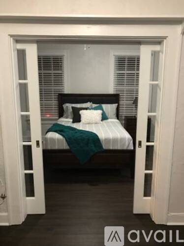 A bedroom with a bed and a window.
