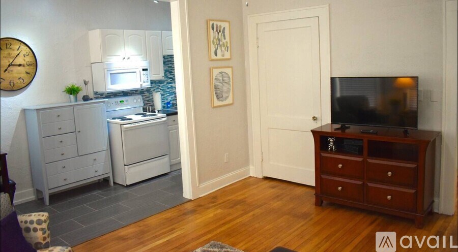 A kitchen with a microwave, oven, and drawers.