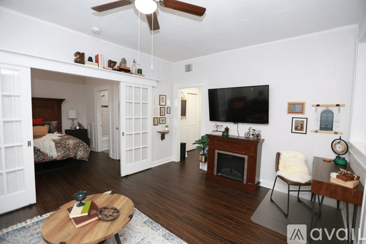 A living room with a fireplace and a television.