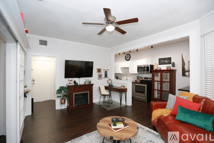 A living room with a red couch and a coffee table.