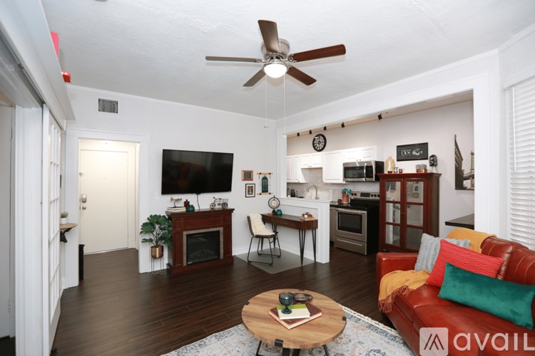 A living room with a red couch and a coffee table.