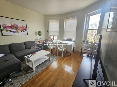 A living room with a grey couch and a white coffee table.