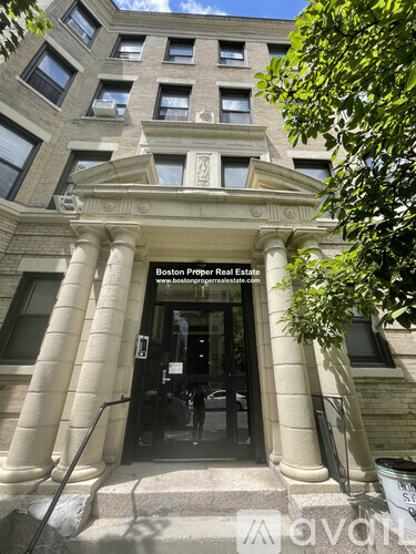 The front of a building with a sign that says Boston Proper Real Estate.