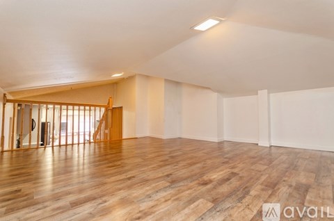A room with wooden floors and a white ceiling.