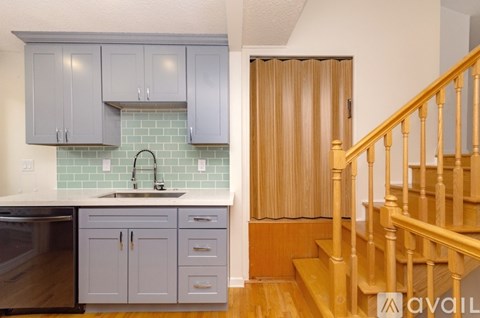 A kitchen with a sink and cabinets.