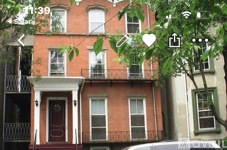 A red brick house with a white door and windows.
