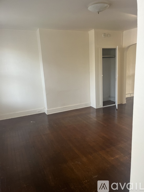 A room with wooden floors and white walls.
