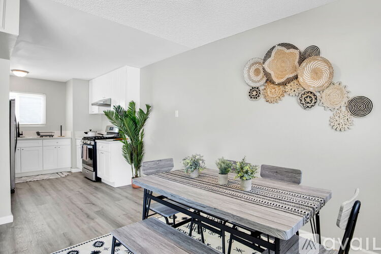 A modern kitchen with a dining table and chairs.