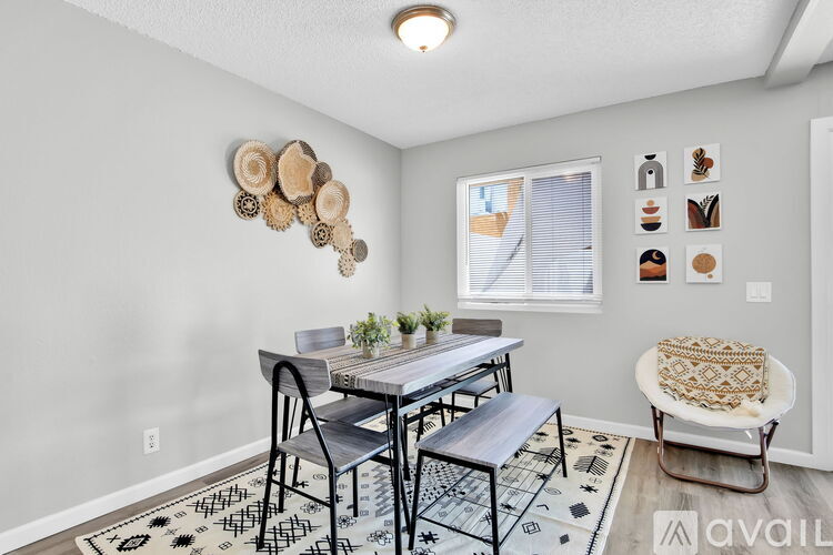 A dining room with a table and chairs.