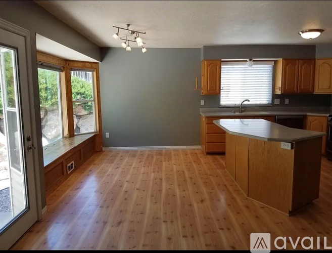 A kitchen with wooden floors and cabinets is available for rent.