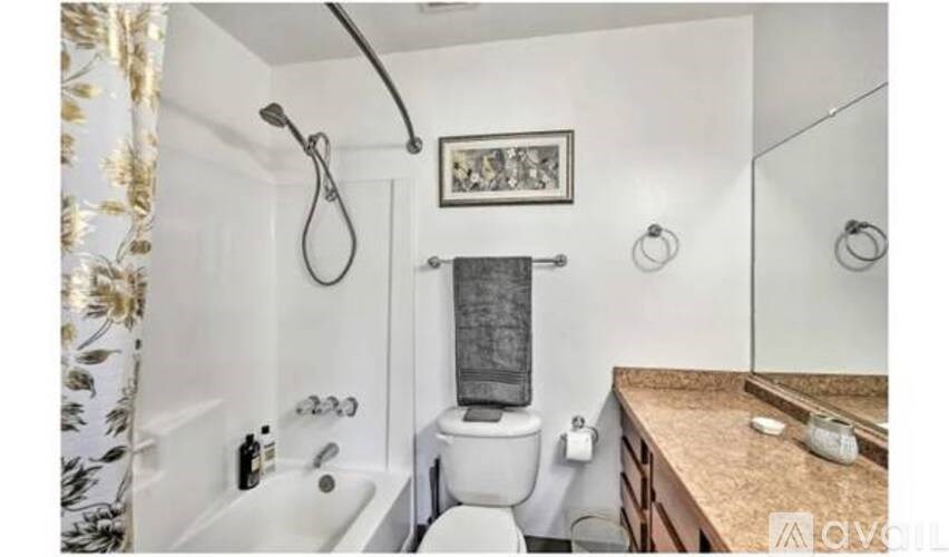 A bathroom with a toilet, sink, and shower.