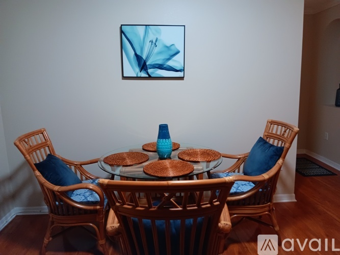A dining room with a glass table and chairs.