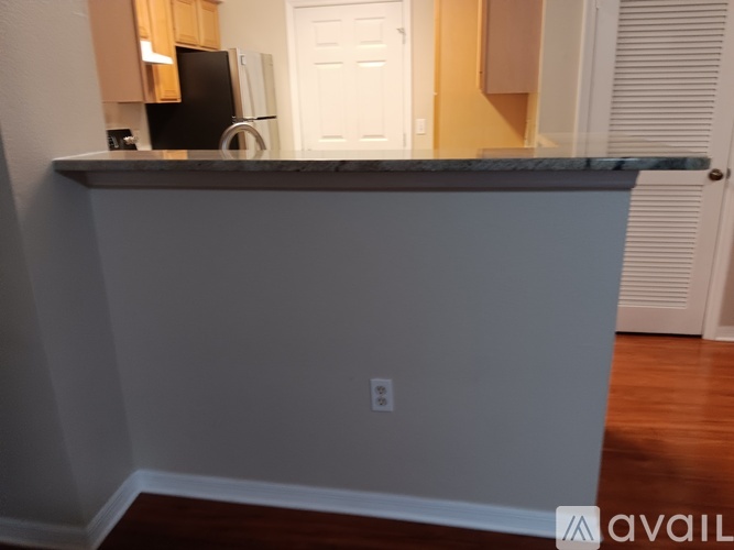 A kitchen counter with a black object on it.