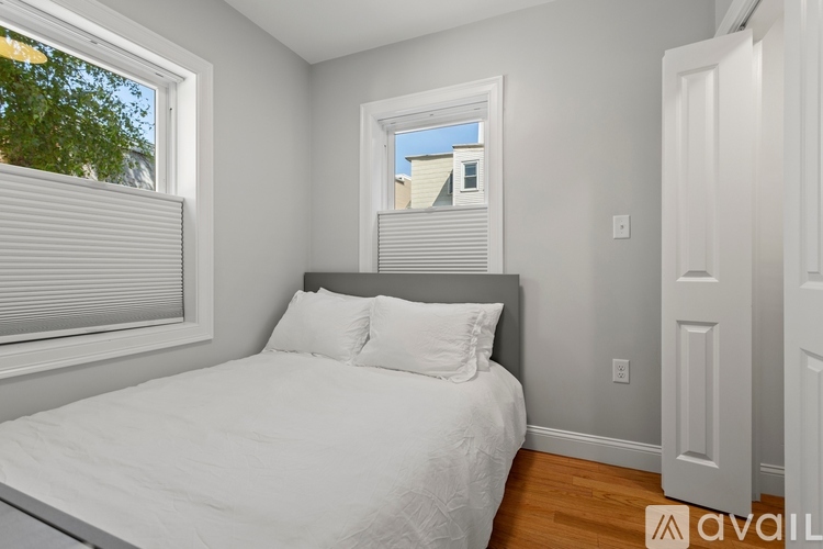 A bedroom with a bed, desk, and chair.