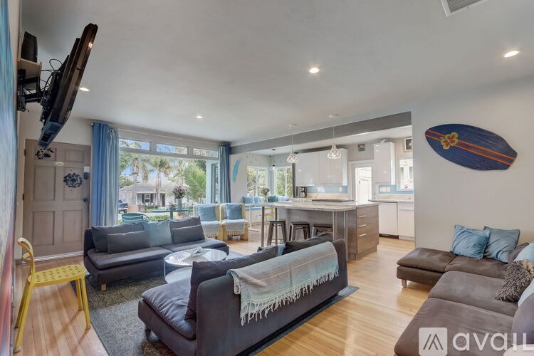 A living room with a grey couch and a yellow chair.