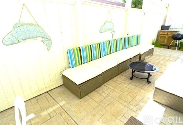 A patio with a bench and a table.