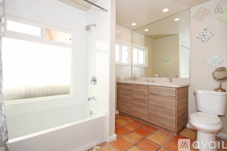 A bathroom with a tub, toilet, and sink.