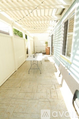 A patio with a table and chairs.