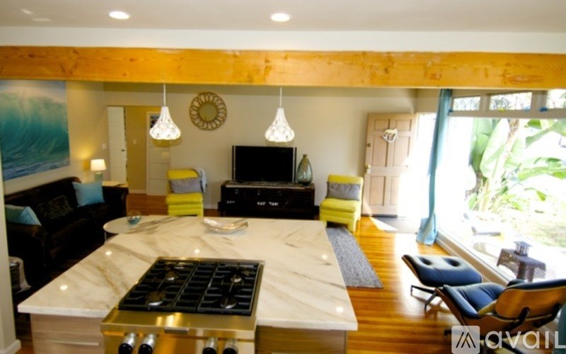 A modern kitchen with a large island and a TV.