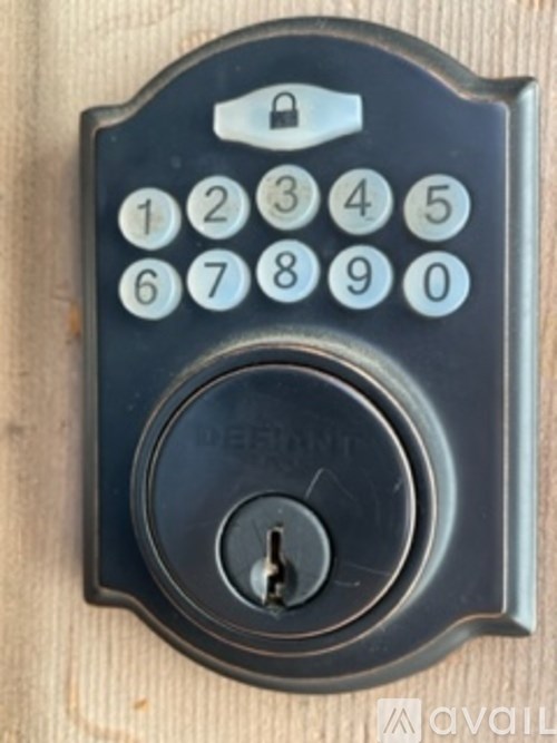 A keypad with numbers 1-9 and 0 is mounted on a wooden surface.
