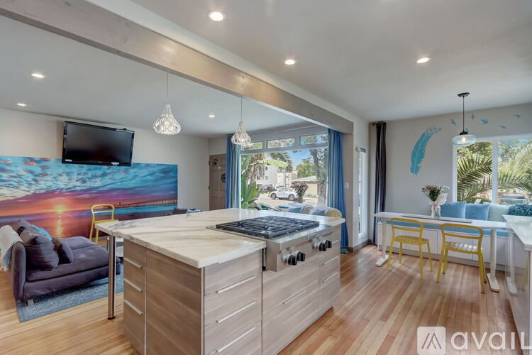 A modern kitchen with wooden cabinets and a large island.
